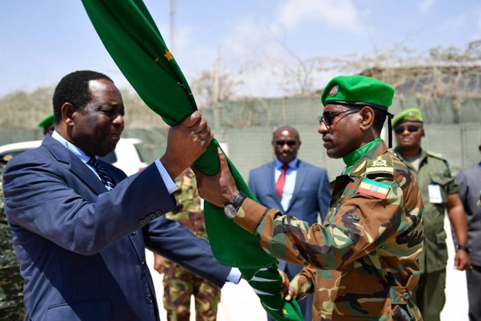 Ambassador Francisco Madeira, the Special Representative of the Chairperson of the African Union Commission (SRCC) for Somalia hands an African Union flag to Lt. Gen. Tigabu Yilma Wondimhunegn, the new AMISOM Force Commander. This was during an AMISOM Force command handover/takeover ceremony in Mogadishu, Somalia, on 31 January 2018. AMISOM Photo / Ilyas Ahmed