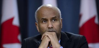 Minister of Immigration, Refugees and Citizenship Ahmed Hussen pauses in Ottawa on Tuesday, May 7, 2019. Immigration Minister Ahmed Hussen says he is concerned by numbers in a new poll that suggest a majority of Canadians believe the government should limit the number of immigrants it accepts since the country might be reaching a limit to its ability to integrate them. THE CANADIAN PRESS/Sean Kilpatrick