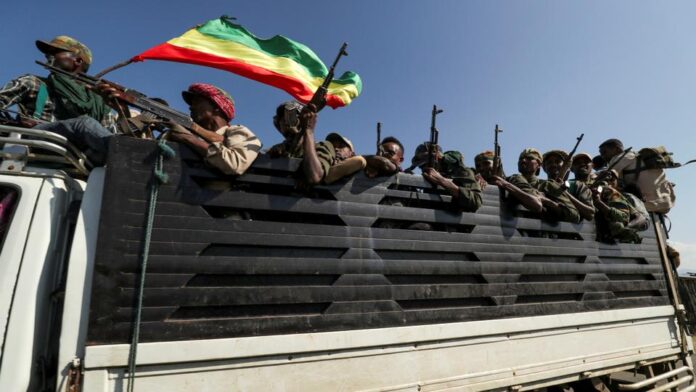 Members of Amhara region militias ride on their truck as they head to face the Tigray People's Liberation Front (TPLF), in Sanja, Amhara region near a border with Tigray, Ethiopia, November 9, 2020. (Reuters)