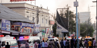 Ambulances and security forces gather on the street outside the Afrik hotel in the capital Mogadishu, Somalia, Jan. 31, 2021. CREDIT AP