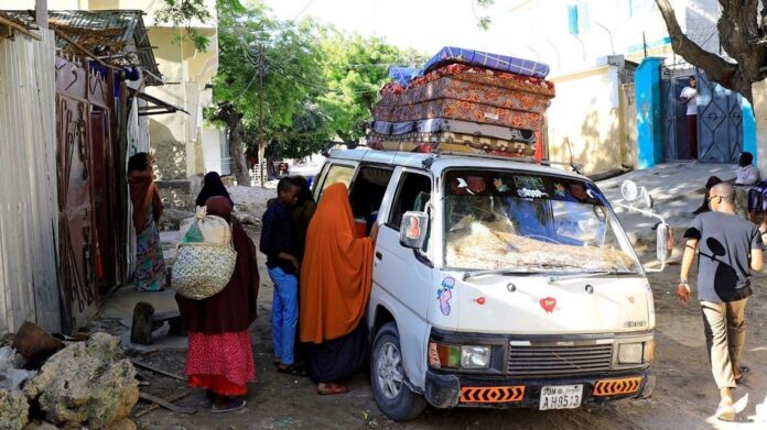 Residents flee following renewed clashes between rival factions in the security forces, who have split in a dispute over an extension to the president's term in Hodan district of Mogadishu, Somalia, on April 27, 2021. (Reuters)
