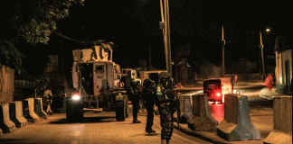 FILE - Police officers of the African Union's peacekeeping mission in Somalia (AMISOM) patrol on a street in Mogadishu, Somalia, Sept. 17, 2019. The country is bracing for attacks by the al-Shabab terror group during upcoming elections.