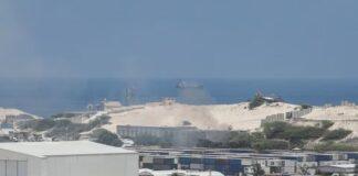 FILE - A general view shows smoke billowing from shipping containers near the Adan Abdulle International Airport international in Mogadishu, Somalia March 23, 2022. REUTERS/Feisal Omar