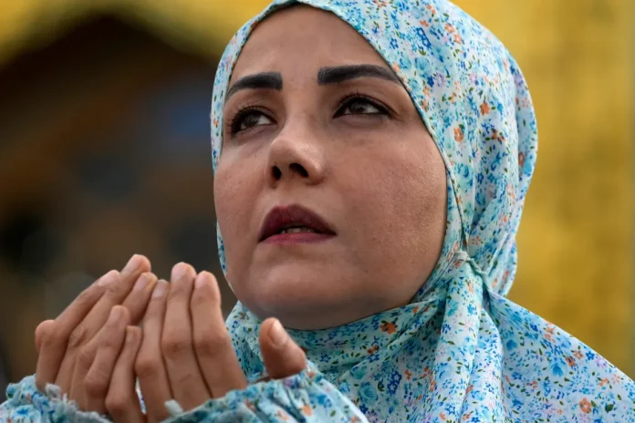 A worshipper performs Eid al-Fitr prayers in Tehran, Iran. [Vahid Salemi/AP Photo]