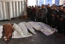 AFP People recite a prayer over the bodies of members of the Palestinian Akasha family, killed in an Israeli strike on the Sheikh Adwan neighbourhood north of Gaza City on November 30, 2024. / Photo: AFP