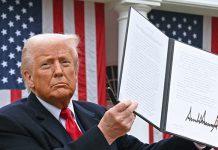 US President Donald Trump holds a signed executive order after delivering remarks on reciprocal tariffs during an event in the Rose Garden entitled “Make America Wealthy Again” at the White House in Washington, DC, on April 2, 2025. (Photo by SAUL LOEB / AFP)